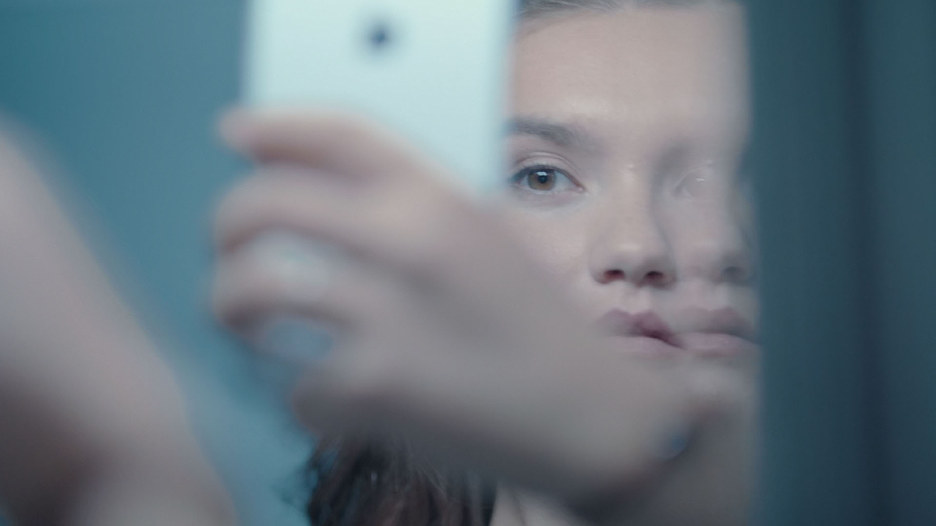 Girl in mirror, taking a photo of herself